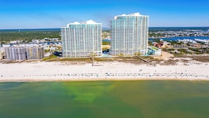 A coastal hotel with two prominent high-rise buildings, a beachfront, and a marina. - Turquoise Place 1206D by Liquid Life (Orange Beach)