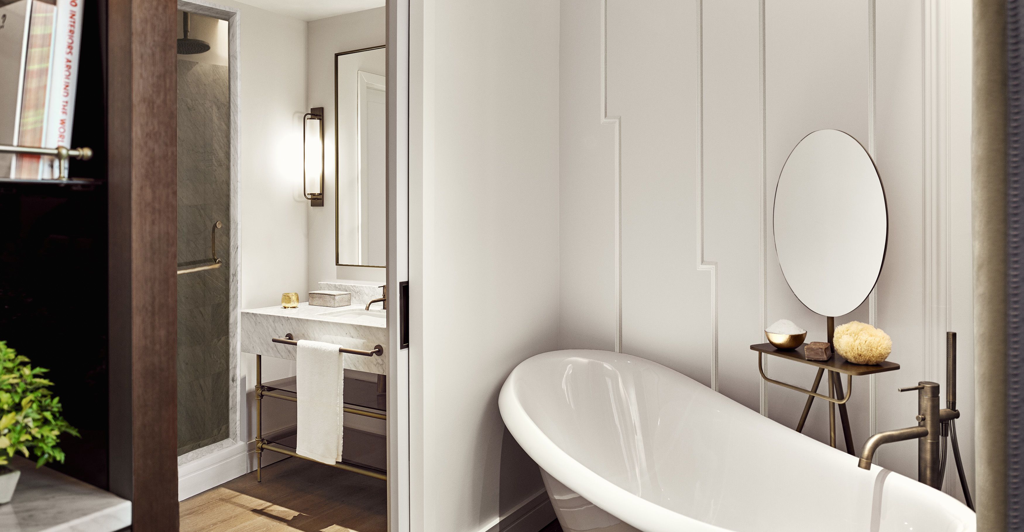 A modern bathroom with a freestanding bathtub, a vanity with a mirror, and a towel rack.