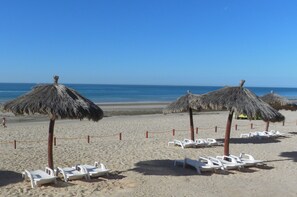 On the beach, sun loungers, beach towels
