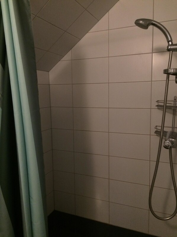 A shower with a handheld showerhead and a wall-mounted faucet. - Eksjö Camping & Konferens - Hostel (Eksjo)