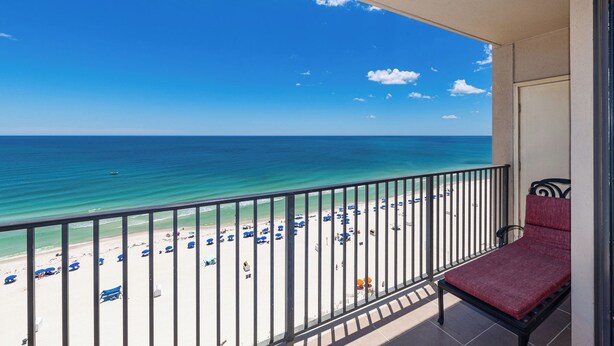 A balcony with a view of a beach, a chair, and a railing. - Gulf Breezes & Ocean Blues 2 Bedroom Phoenix X 1416 (Orange Beach)