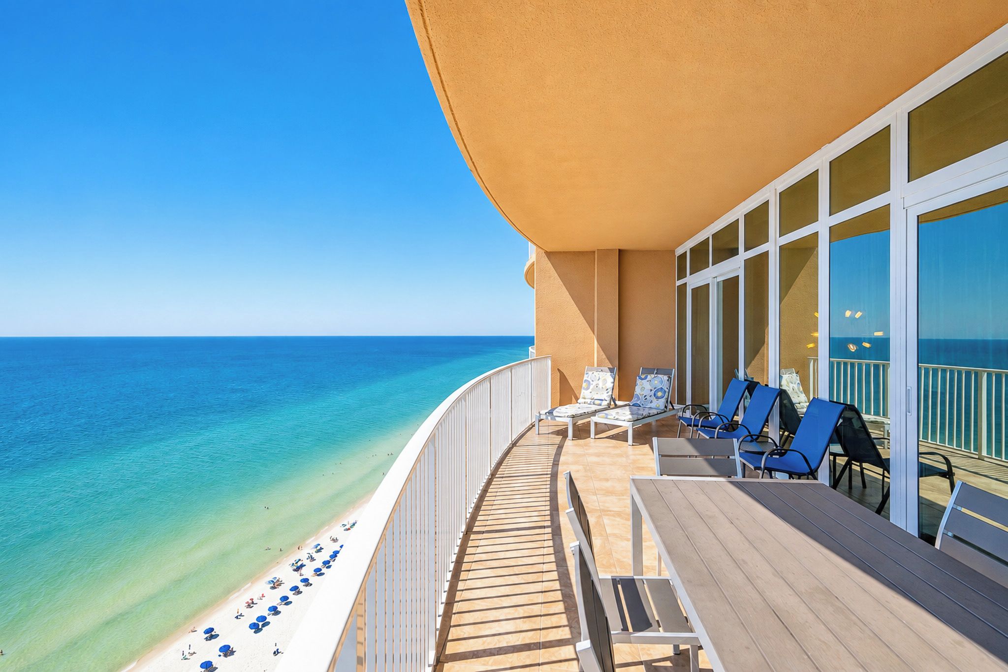 A deck with lounge chairs and a view of the ocean.