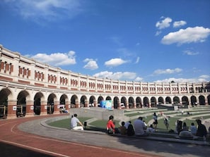 A large, historic building with multiple arches and a central courtyard.