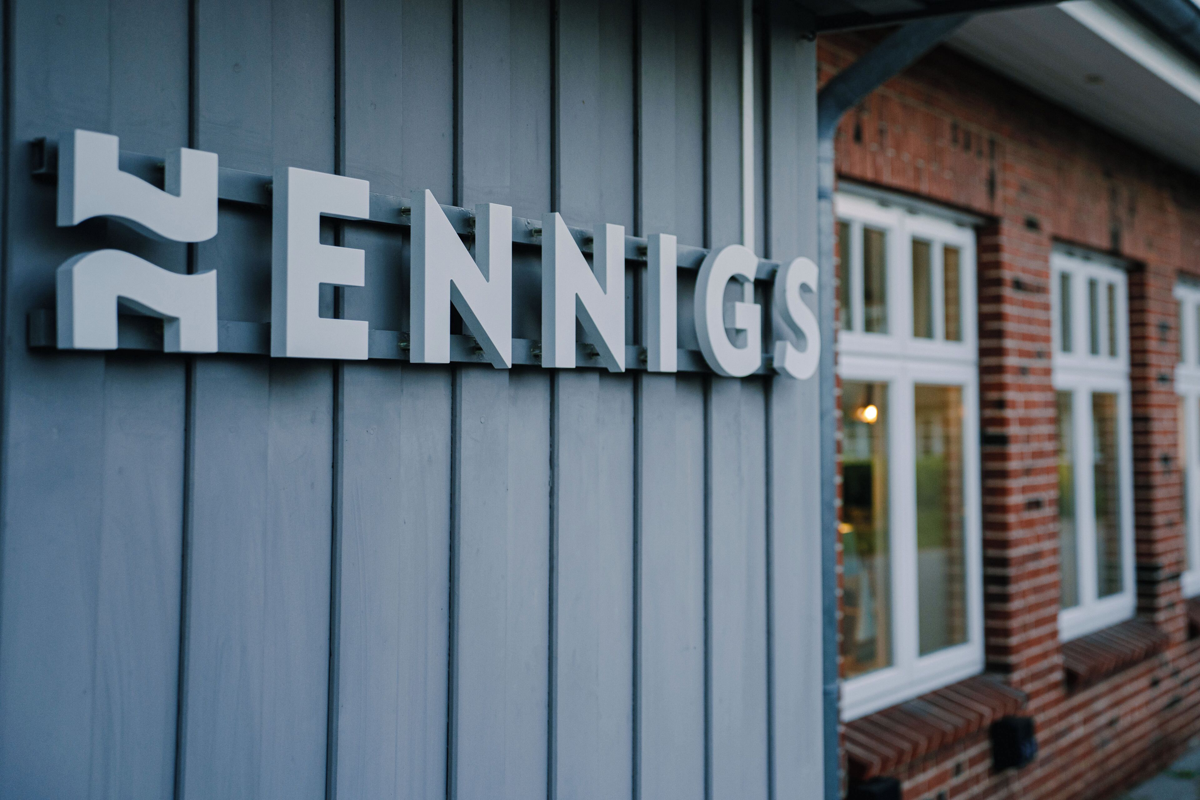 A building with a sign that reads 'ENNIGS' on a grey facade.