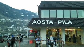 Un edificio con el cartel 'AOSTA-PILA' que indica una estación de esquí.
