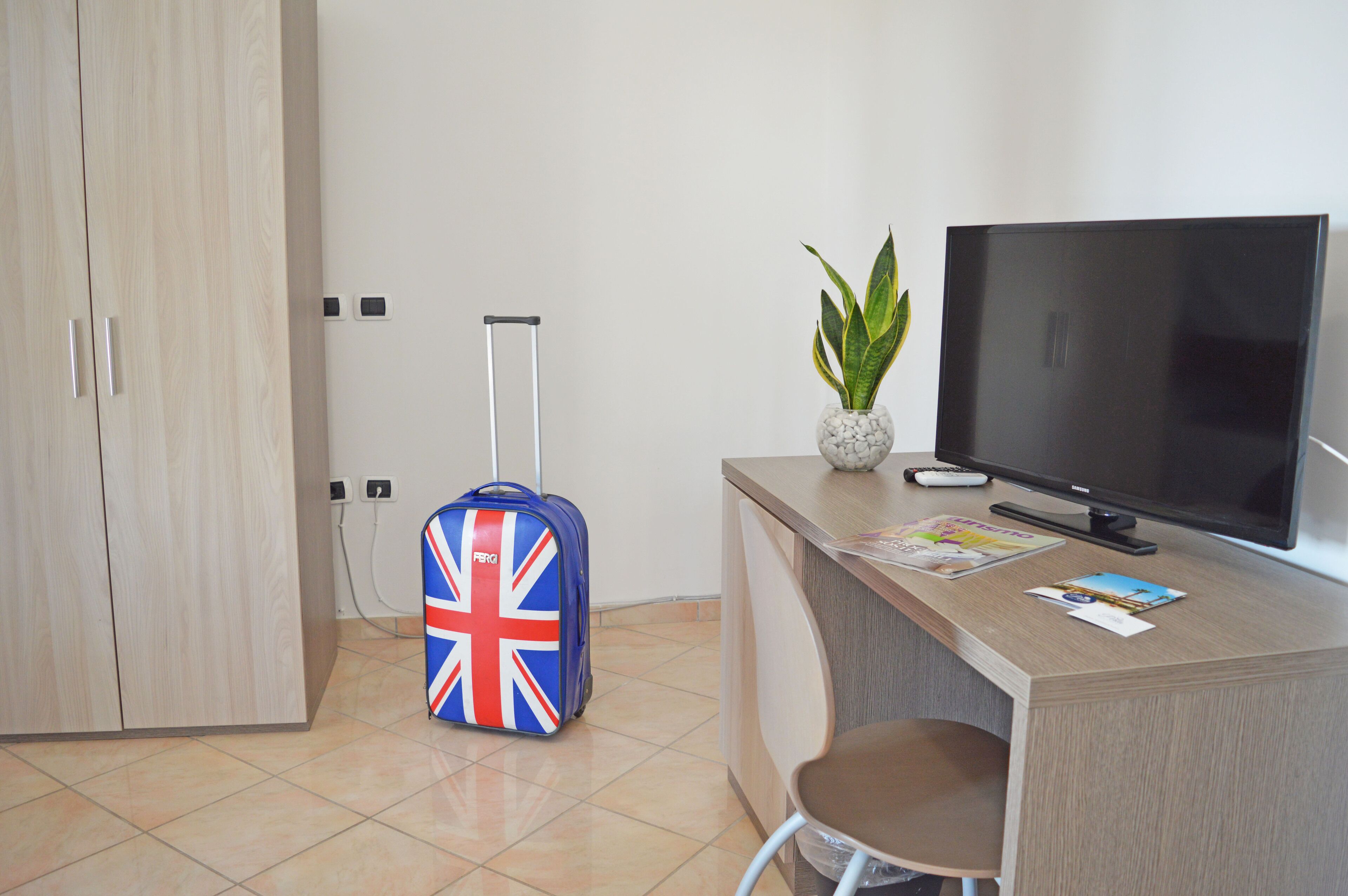 superior quadruple room, multiple beds | television