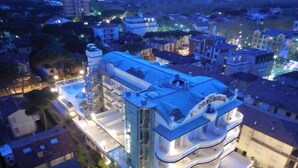 A multi-story hotel with a modern design, featuring balconies and a rooftop terrace. - Hotel Conchiglia (Cervia)