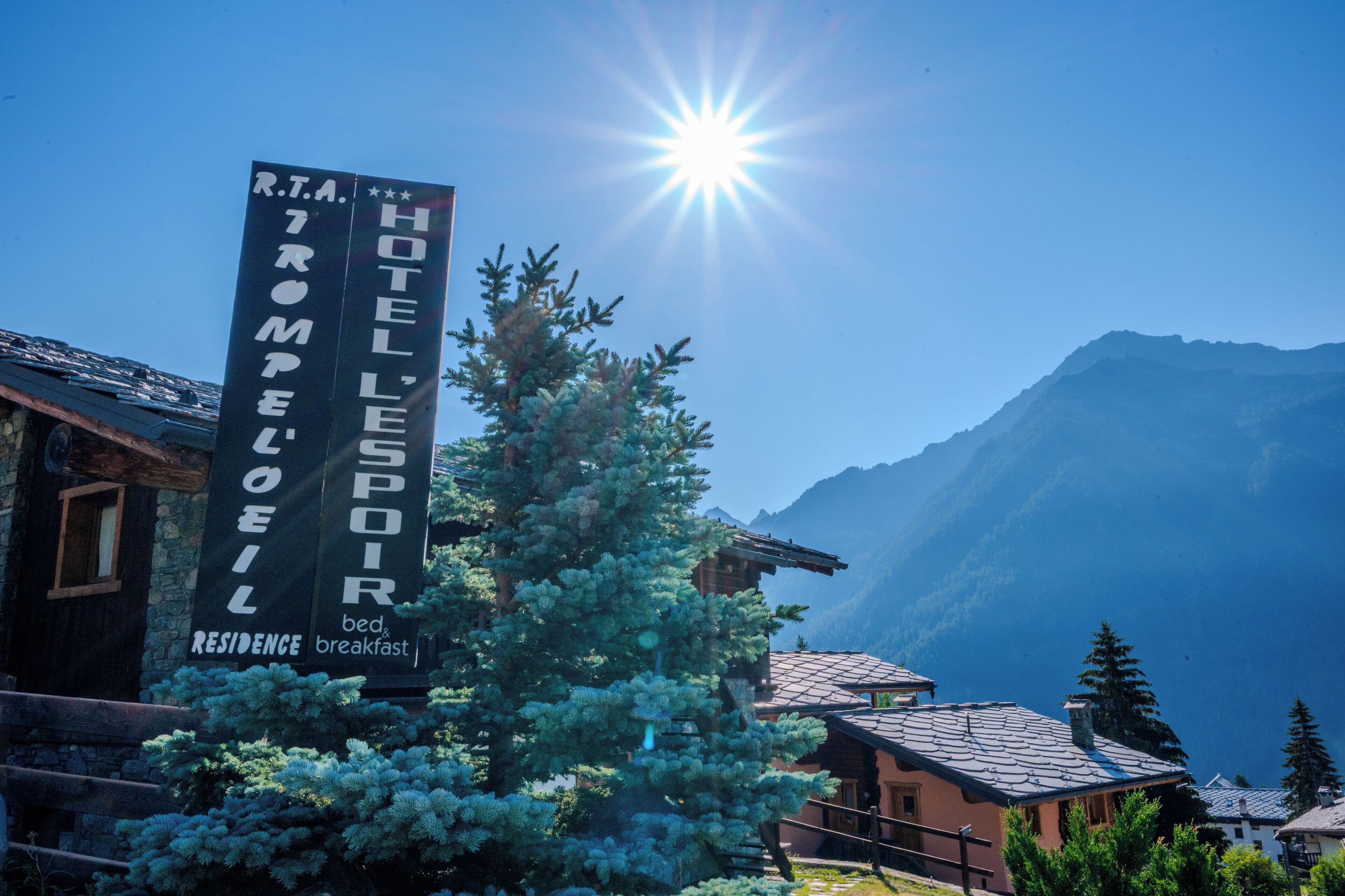 Un complejo turístico de montaña con un cartel que anuncia el hotel 'R.T.A. HOTEL L'ESPOR'.