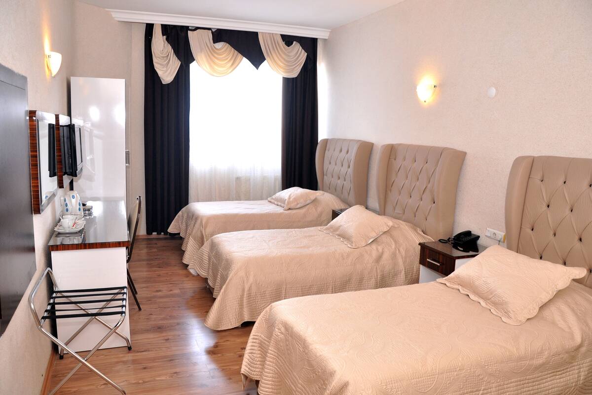 Habitación triple | Ropa de cama de alta calidad y minibar