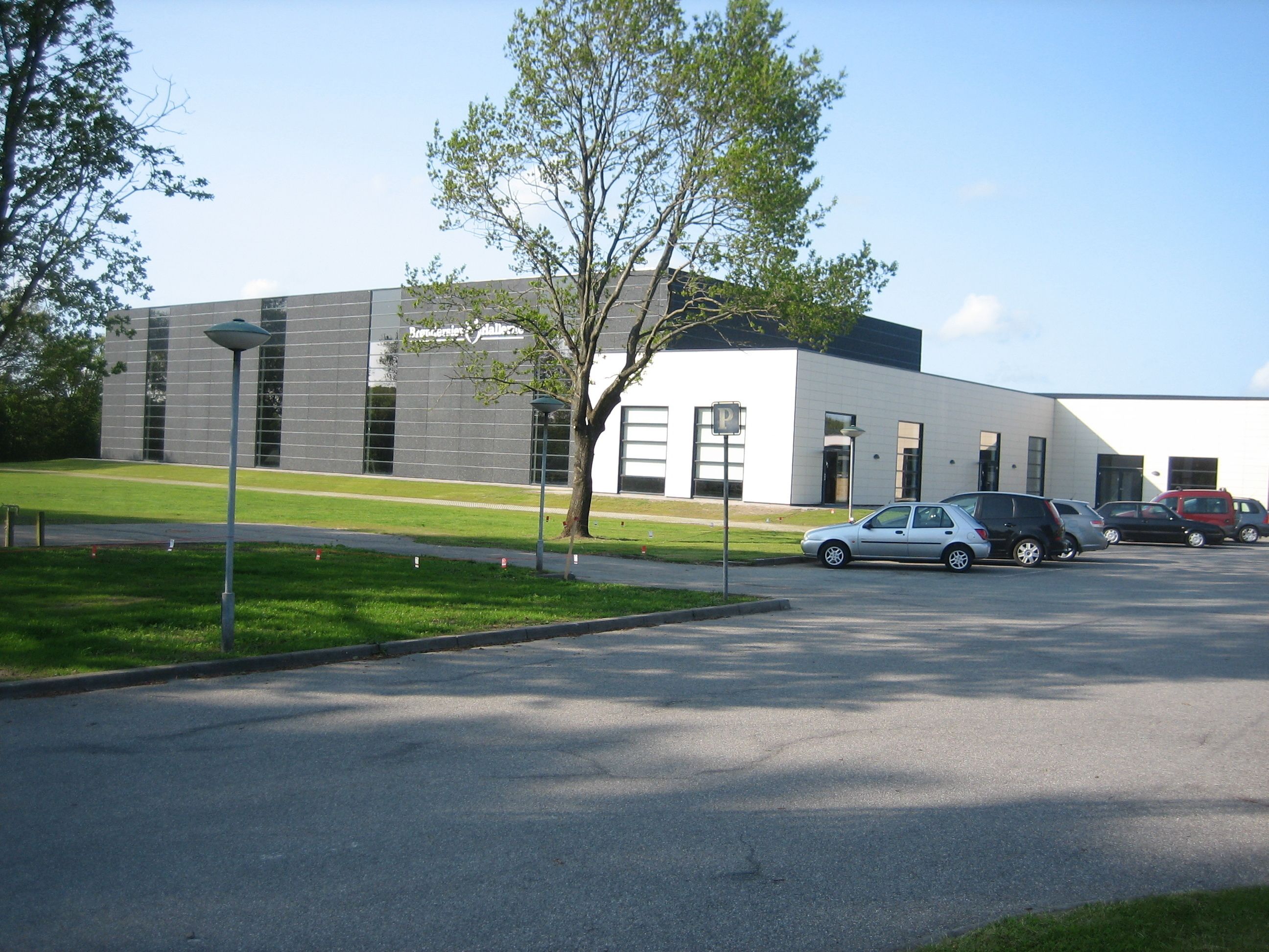 A modern building with a parking lot.