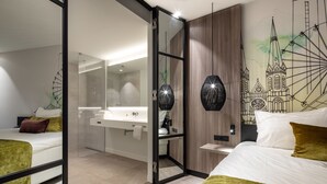 A modern hotel room with a large bed, a separate bathroom, and a mural of a cathedral. - Van der Valk Hotel Tilburg (Tilburg)