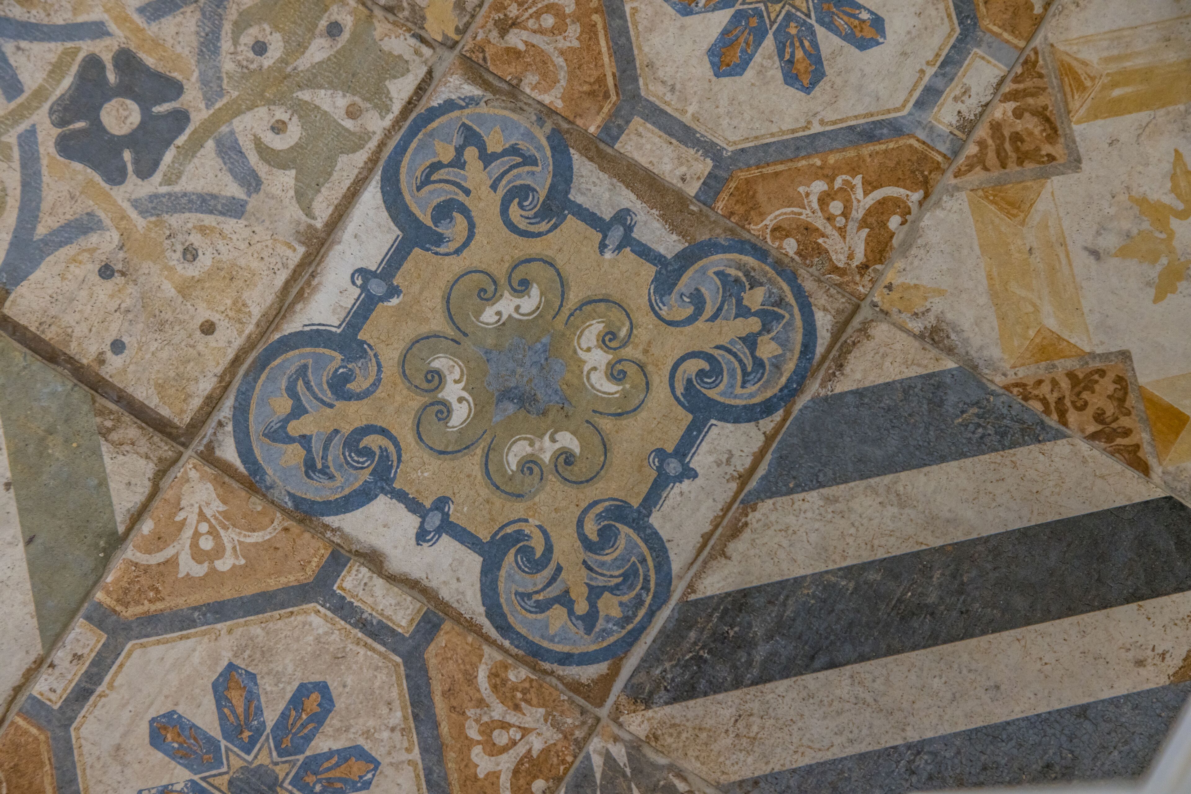 A close-up of a tiled floor with intricate patterns and designs.