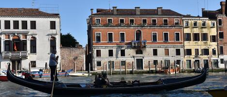 A gondola on a canal in Venice, with buildings in the background.