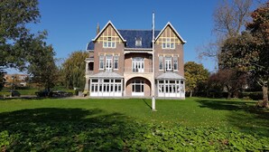 A large, two-story house with a symmetrical facade, multiple windows, and a prominent central entrance. - Rijksmonument Hotel de Sprenck (Middelburg)