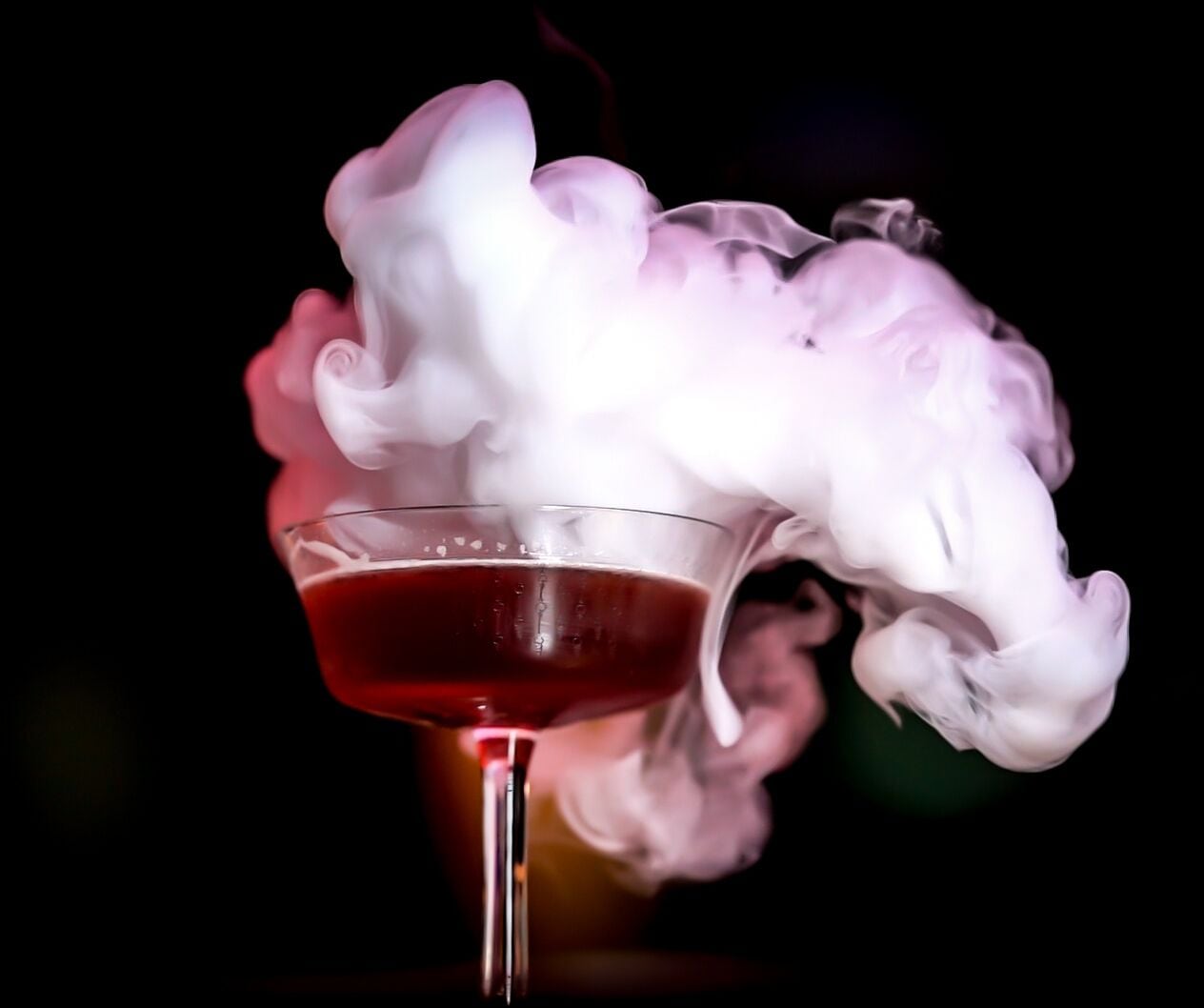 A cocktail with a smoky effect in a glass.