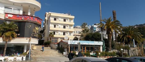 A hotel with a curved facade, multiple balconies, and a sign for 'Roule Palace'.