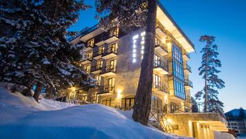 Hotel rooms offer expansive views from large windows and balconies.