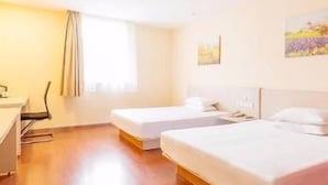 A hotel room with two single beds, a desk, and a chair. - Hanting Hotel (Shaoxing)