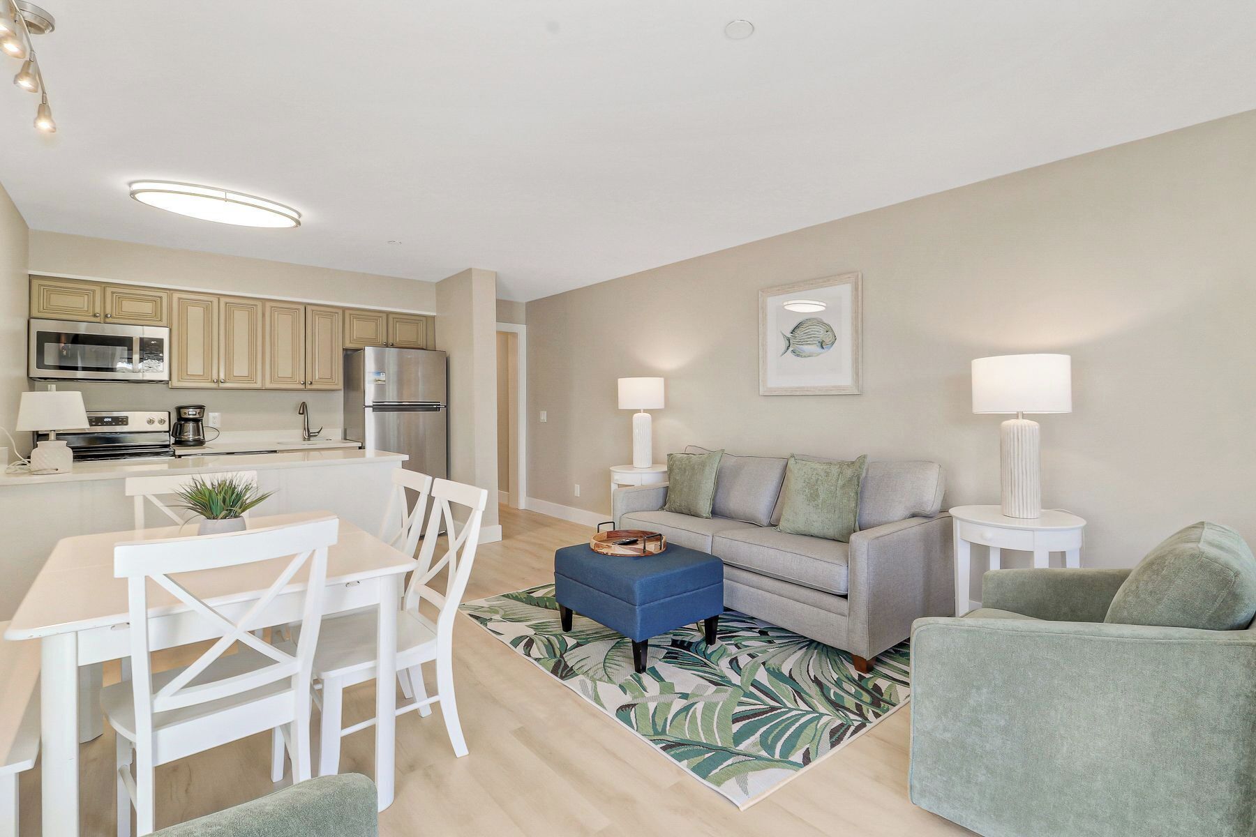 A modern apartment with a kitchen, dining area, and living room.