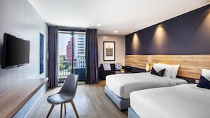 A modern hotel room with two beds, a desk, and a TV. - Narra Hotel (Bangkok)