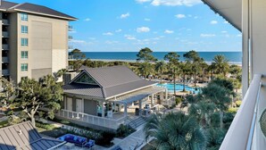 A hotel with a pool, outdoor seating, and a view of the beach. - Breathtaking Views! Heated Oceanfront Pool! (Hilton Head Island)
