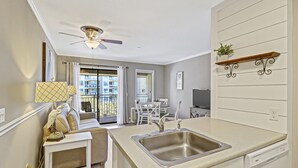 A modern kitchen with a central island, a built-in dishwasher, and a ceiling fan. - Breathtaking Views! Heated Oceanfront Pool! (Hilton Head Island)
