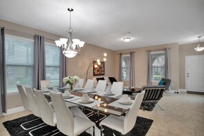 Enjoy meals in this stylish dining area with a glass-top table and comfortable seating.