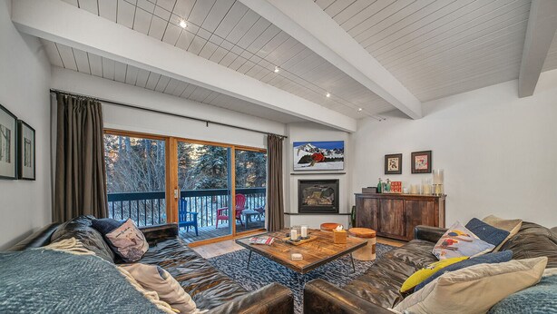 A cozy living room with a large sofa set, a coffee table, and a fireplace. - Riverside C03 A Mountain Forest Hideaway - 2 Bedrooms, 2 Bathrooms, Sleeps 6 (Telluride)