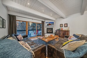 A cozy living room with a large sofa set, a coffee table, and a fireplace. - Riverside C03 A Mountain Forest Hideaway - 2 Bedrooms, 2 Bathrooms, Sleeps 6 (Telluride)