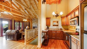 A spacious kitchen with wooden cabinets, a granite countertop, and a built-in oven.