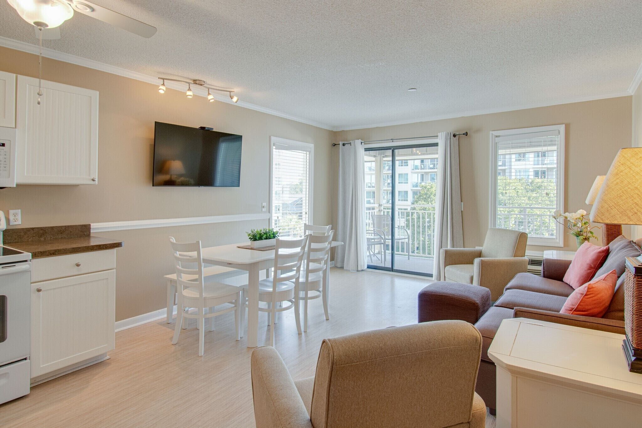 A modern apartment with a kitchen, dining area, and living room.
