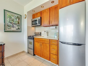 Fridge, microwave, oven, stovetop - Say “Aloha” to Ocean Views, Free WiFi, Modern Kitchenette – Waikīkī Shore 1214 (HONOLULU)