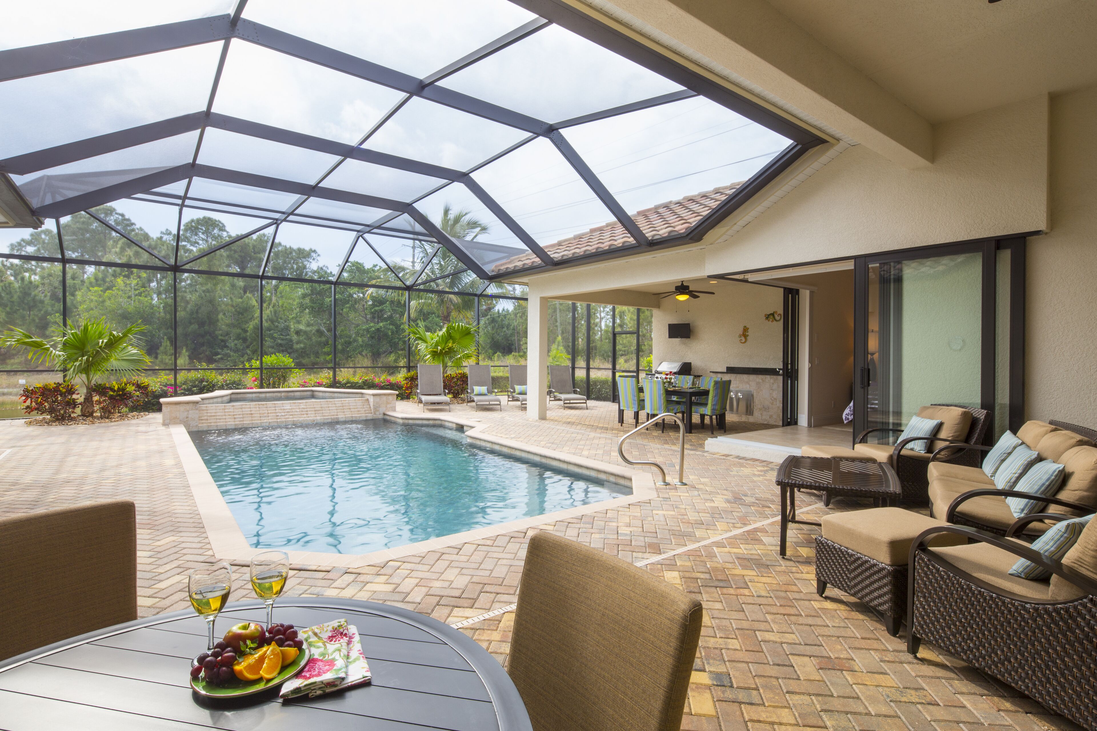 overlooking a nature preserve and lake, this pool with spa home has it all