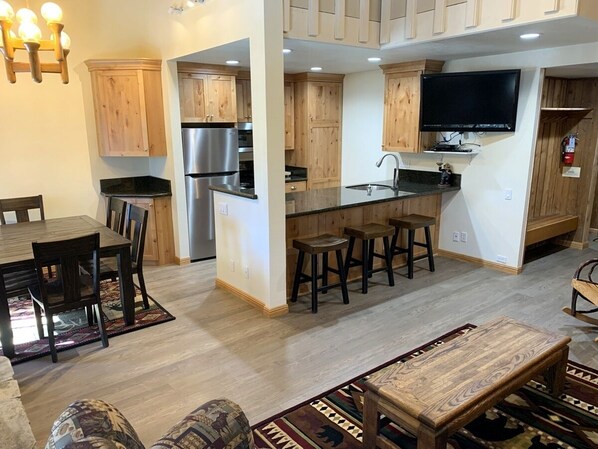 Enjoy cooking in this well-equipped kitchen with an island, refrigerator, and stove.