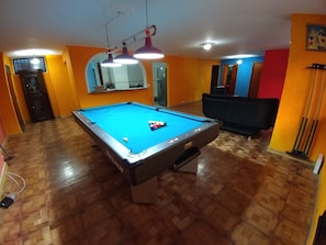 Pool table looking toward living room area & kitchen