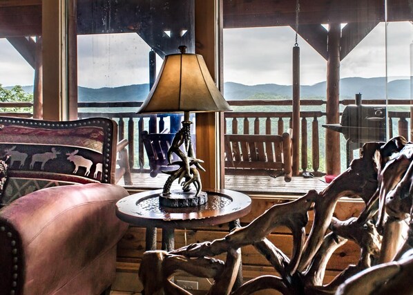 Relax in this inviting space with a leather armchair and scenic views of distant mountains from the balcony.