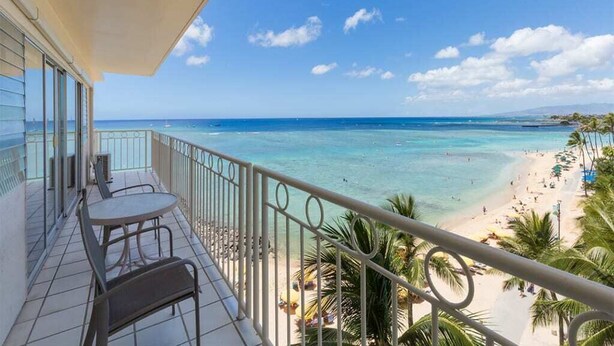 Ein Balkon mit Blick auf Strand und Meer.