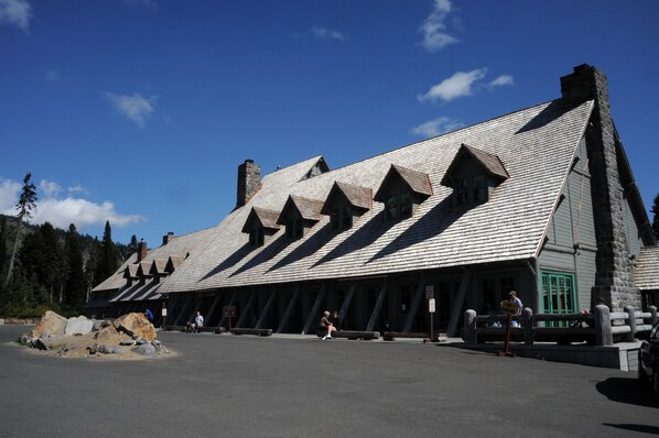 A building with a steeply pitched roof and multiple gabled sections. - Paradise Inn (Ashford)