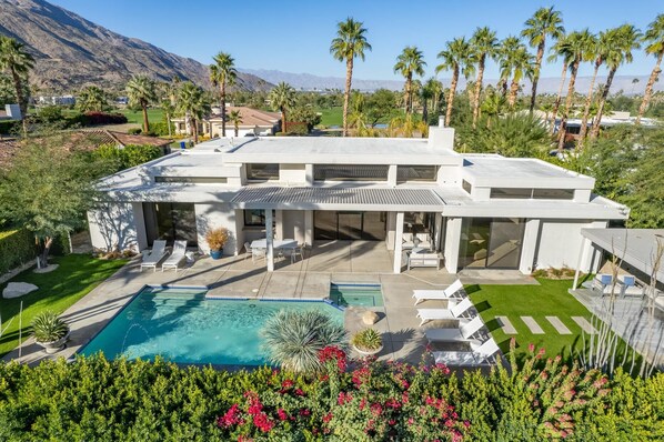 A modern house with a swimming pool, patio, and mountain views. - Pet-Friendly Gated Home near Downtown (Palm Springs)