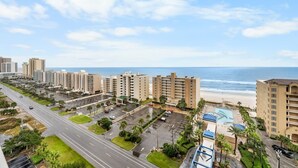 A coastal hotel with multiple buildings, a parking lot, and a beach view. - Gulf Shores Condo with Gulf Views | Lazy River, Pools, and Hot Tub | Sleeps 6 (Gulf Shores)