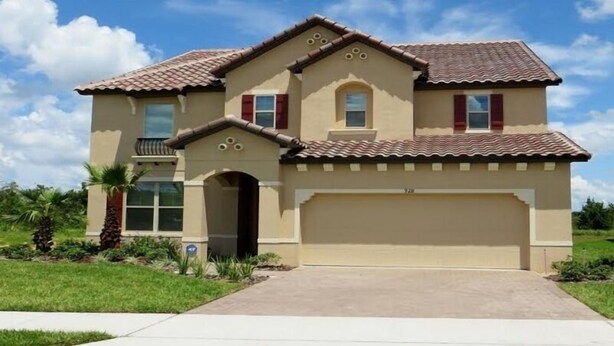 A two-story house with a tiled roof, a garage, and a front entrance. - Luxurious Home with Private Pool Upstairs  Games Room. 928 (Davenport)