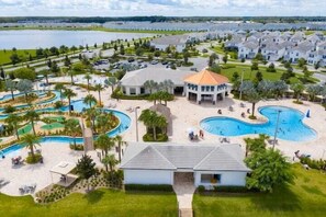 A residential area with multiple houses, a swimming pool, and a small building with a dome roof. - Minutes to Disney | Private Pool, Resort Amenities & BBQ Grill - 1600ST (Kissimmee)