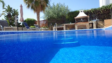 A heated pool, pool loungers