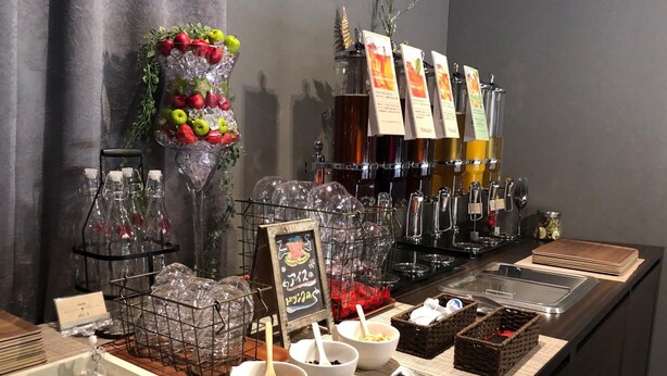 A buffet setup with various food items, including fruits and beverages. - Restay Hiroshima - Adult Only (Hiroshima)