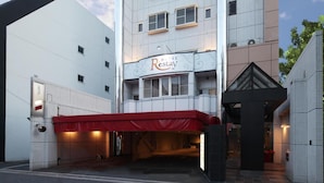 A hotel with a modern facade, a red awning, and a sign that reads "Hotel Restay." - Restay Hiroshima - Adult Only (Hiroshima)