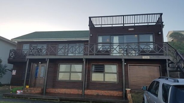 A two-story building with a balcony and a garage. - 303 Kusweg (Great Brak River)