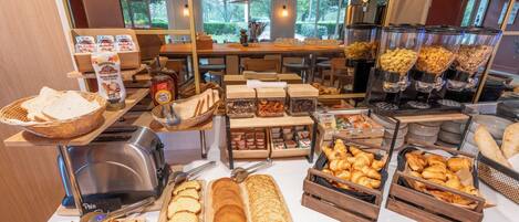 A breakfast buffet with various food items and a toaster.