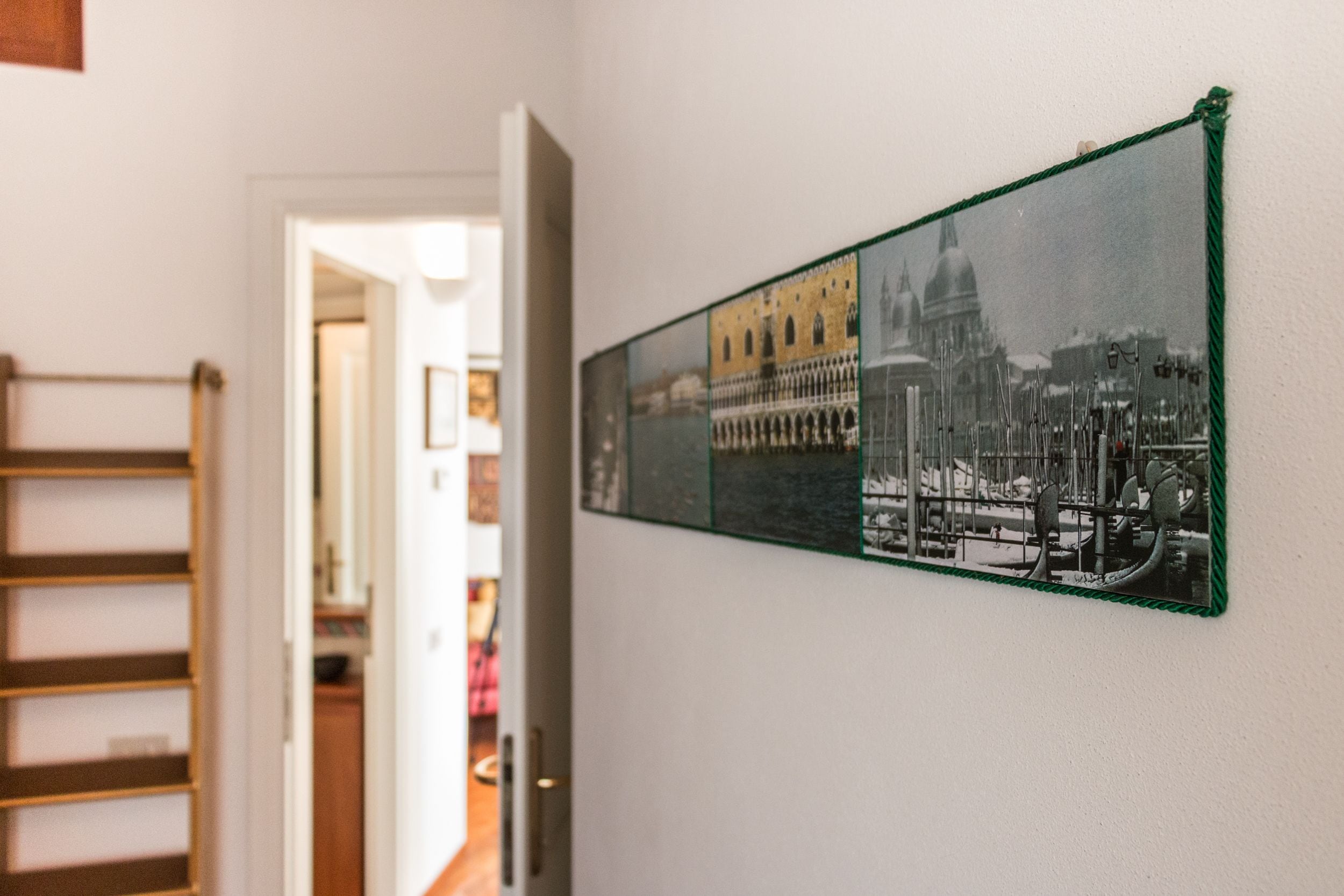 A hallway with a wall-mounted photo collage of historical buildings.