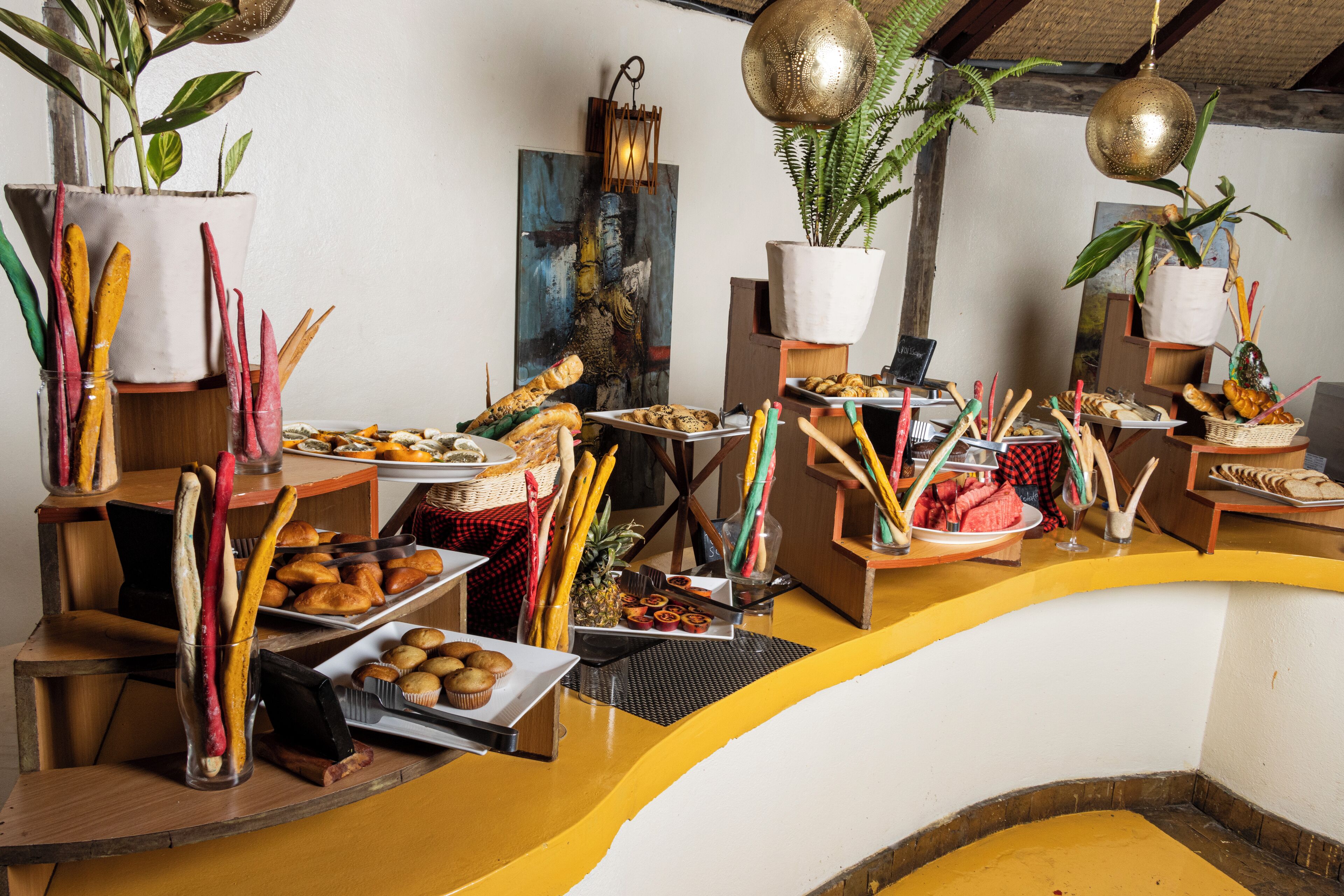 A buffet setup with various food items and decorative elements.