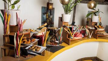 A buffet setup with various food items and decorative elements.